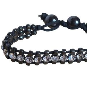 Black corded bracelet with white silver tone rhinestones with beaded closure